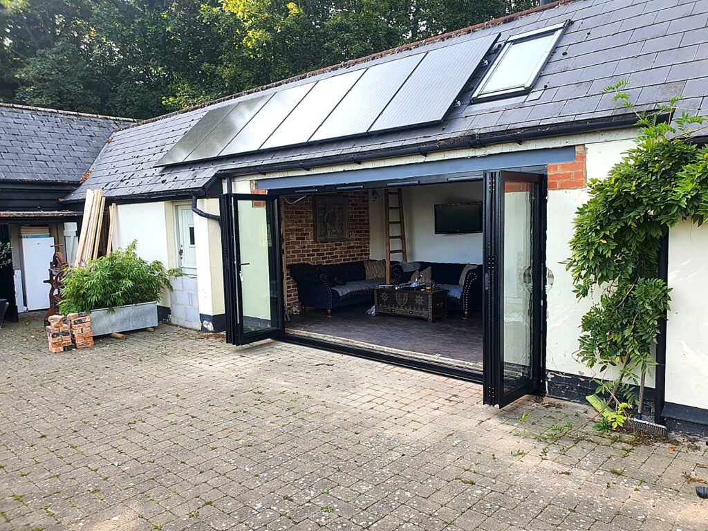 Black aluminium bi-fold doors installed on a residential property